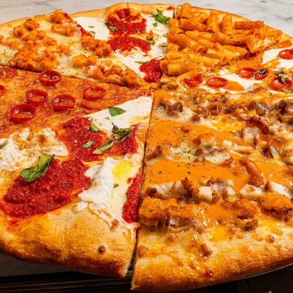 A large pizza with eight different slices, including pepperoni, pasta, and various chicken toppings.
